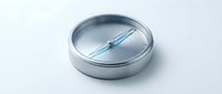 Metallic compass with blue needle on white isolated background, ready for design projects, web graphics, and educational materials.