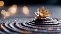Zen meditation stone with golden lotus flower on rippled water surface creating peaceful spa atmosphere with warm bokeh lights background.