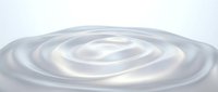 Smooth liquid ripples create concentric circles on translucent surface, ideal for abstract backgrounds, web design, and modern digital projects.