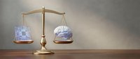 Golden balance scale weighing human brain against money banknotes on wooden desk, representing choice between intelligence and wealth in business decisions.