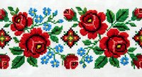 Traditional cross-stitch embroidery pattern with red roses, blue flowers and green leaves on white fabric background for crafting projects.