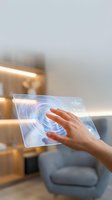 Hand touching futuristic holographic interface with circular digital elements in modern smart home interior for technology applications.