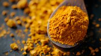 Vibrant orange turmeric powder heaped on wooden spoon against dark background, scattered aromatic spice grains create depth and texture for culinary and wellness designs.