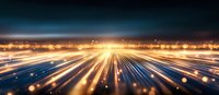 Abstract technology background with glowing light trails and bokeh effects creating dynamic motion perspective against dark horizon, suitable for digital innovation concepts.