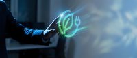Businessman hand touching glowing green eco leaf symbol with digital energy effects representing sustainable technology and environmental innovation concepts.