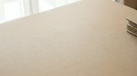 Clean beige fabric texture surface with soft natural lighting for interior design and upholstery projects.