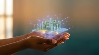 Hands holding glowing holographic cityscape with digital buildings and light particles, representing smart city technology, urban development, and innovation for business concepts.