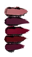 Crushed lipstick smears in various shades of burgundy, wine, and deep red arranged vertically on white background, showing texture and pigment intensity.