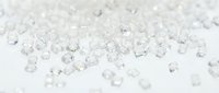 Scattered transparent crystal cubes and geometric glass fragments on white surface, suitable for luxury product backgrounds, jewelry displays, and modern design projects.