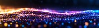 Colorful glowing particle wave with blue, purple, and orange light effects against dark background, creating abstract digital landscape.