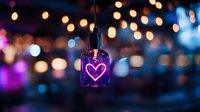Glowing neon heart sign in glass pendant lamp against blurred bokeh lights background creates romantic atmosphere for Valentine's day or wedding decor.