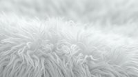 White fluffy fur texture background with soft fibers creating cozy material surface for interior design and textile applications.