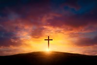 Silhouette of Christian cross on hill against dramatic sunset sky with glowing orange clouds and sunbeams, symbolizing faith, hope and spirituality.