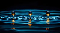Mesmerizing water drops creating symmetrical ripples with golden reflections on dark blue surface, captured in high-speed macro photography showing liquid dynamics.