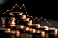 Declining financial graph with stacked golden coins showing downward market trend on dark background, perfect for economic crisis or investment risk concepts.