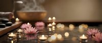 Relaxing spa scene with floating lotus flowers, candles and singing bowl creating peaceful wellness atmosphere for meditation and self-care rituals.