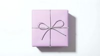 Pink gift box with ribbon bow on white background isolated for holiday celebration design.