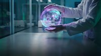 Scientist in white lab coat holding glowing holographic sphere with digital data visualization in modern laboratory for technology research and innovation.