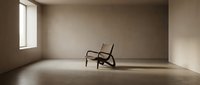 Minimalist empty room with single wooden chair and natural light from window, suitable for interior design and architectural visualization projects.