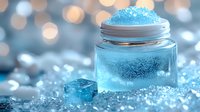 Magical glowing blue jar with sparkling crystals and ice cube on shimmering bokeh background creates ethereal winter atmosphere for holiday designs.