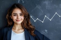 Young Hispanic businesswoman with long brown wavy hair and white blouse standing against chalkboard with growing chart graph. Professional corporate portrait.