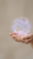 Hands holding glowing energy orb with swirling light effects for spiritual healing wellness meditation and holistic therapy concepts.