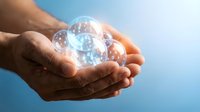 Hands holding glowing digital globe with network connections, representing global business, technology innovation, and worldwide connectivity for corporate communications.