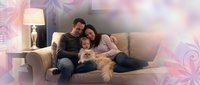 Happy young Caucasian family with toddler and golden retriever dog relaxing together on beige sofa in modern living room with warm lighting and decorative elements.