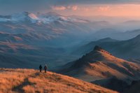 Two hikers standing on golden mountain ridge at sunset with layered peaks and warm alpine glow creating dramatic landscape vista for outdoor adventure content.