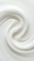 Creamy white swirl texture with smooth, glossy surface showing rich dairy product consistency, suitable for cosmetics, skincare, food, and beauty industry marketing materials.