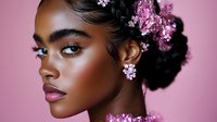 Young African American woman with glowing skin and pink cherry blossoms in dark braided hair against pink background, side profile portrait showcasing natural beauty and floral elements.