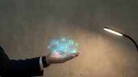 Businessman hand holding glowing digital icons representing technology, connectivity, and data management solutions for corporate business applications.