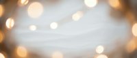 Soft golden bokeh lights creating dreamy blurred background with warm glowing circles and gentle luminous effects for romantic designs.