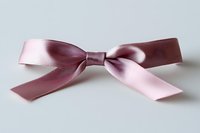 Pink satin bow ribbon isolated on white background. Elegant decorative element for gift wrapping, fashion accessories, and craft projects. Ready for design use.