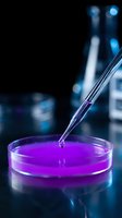 Laboratory pipette dropping purple liquid into petri dish for scientific research and chemical analysis in modern lab setting.