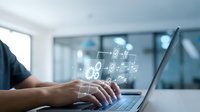 Businessman typing on laptop with digital network icons floating above keyboard in modern office environment for technology and connectivity concepts.