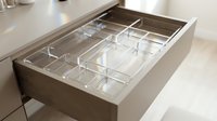 Modern kitchen drawer with transparent acrylic organizer compartments for utensils and cutlery storage in contemporary home interior design.