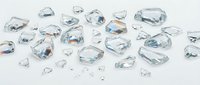 Scattered crushed ice cubes and frozen water shards on white background, suitable for beverage, food, and cooling product design projects.