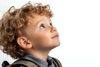 Young Caucasian boy with curly blonde hair looking up with wonder and curiosity against white background, profile view showing innocent expression and natural lighting.