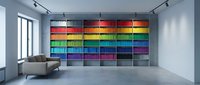 Modern interior design studio with colorful paint sample wall display featuring rainbow spectrum swatches for creative projects and home decoration planning.