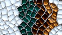 Colorful mosaic tiles in white, emerald green, and amber brown arranged in a gradient pattern, ideal for backgrounds, design projects, and decorative applications.