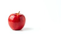 Fresh red apple with water droplets isolated on white background for healthy eating and nutrition concepts.