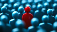 Single red figure standing out from crowd of blue figures, leadership concept showing individuality, uniqueness and different thinking approach in business.