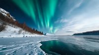 Northern lights dance over frozen lake landscape with snow-covered shore and forest silhouettes against dramatic aurora borealis in night sky, reflecting on icy surface.