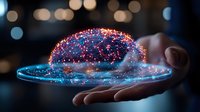 Glowing digital brain hologram floating over open palm against dark background with bokeh lights, representing artificial intelligence and future technology.