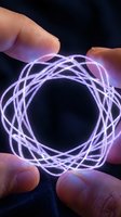 Human hands holding glowing purple energy sphere with intricate light patterns for futuristic technology and innovation concepts.