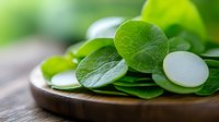 Fresh watercress leaves and sliced white radish on wooden plate, macro view with selective focus. Natural organic ingredients for healthy salad.