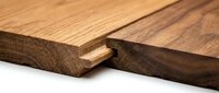 Tongue and groove wooden planks joint closeup, showing natural oak texture and warm brown tones for flooring and carpentry projects.