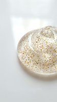 Elegant cream ceramic bowl with gold speckled pattern and soft swirled texture on white background for modern kitchen and home decor styling.