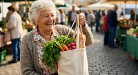 Senior Caucasian woman smiling while holding eco-friendly shopping bag filled with fresh vegetables at outdoor farmers market for healthy lifestyle.